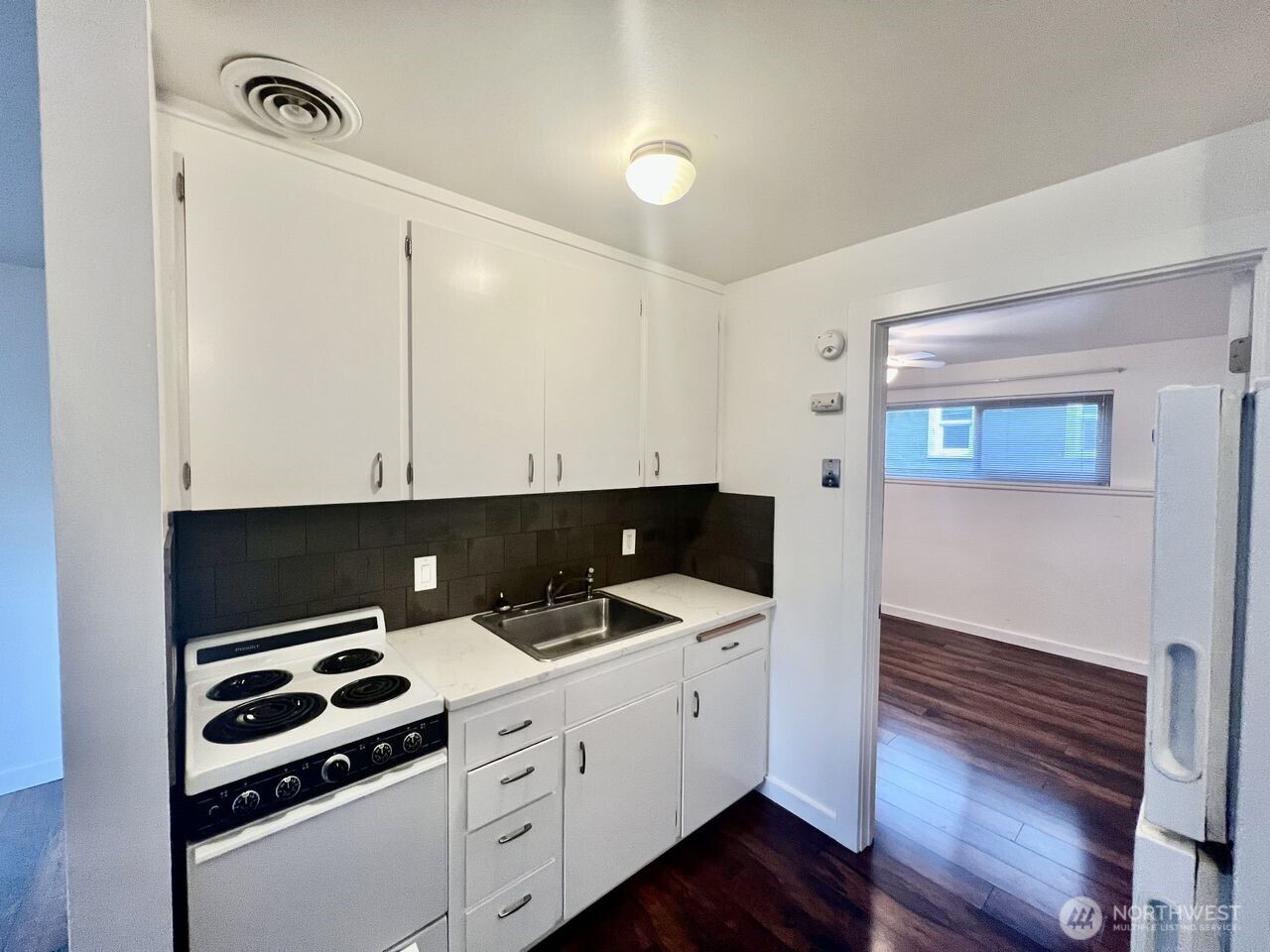 4200 Fremont Avenue North Seattle, WA 98103 - Photo 11 of 17 a kitchen with a sink and cabinets