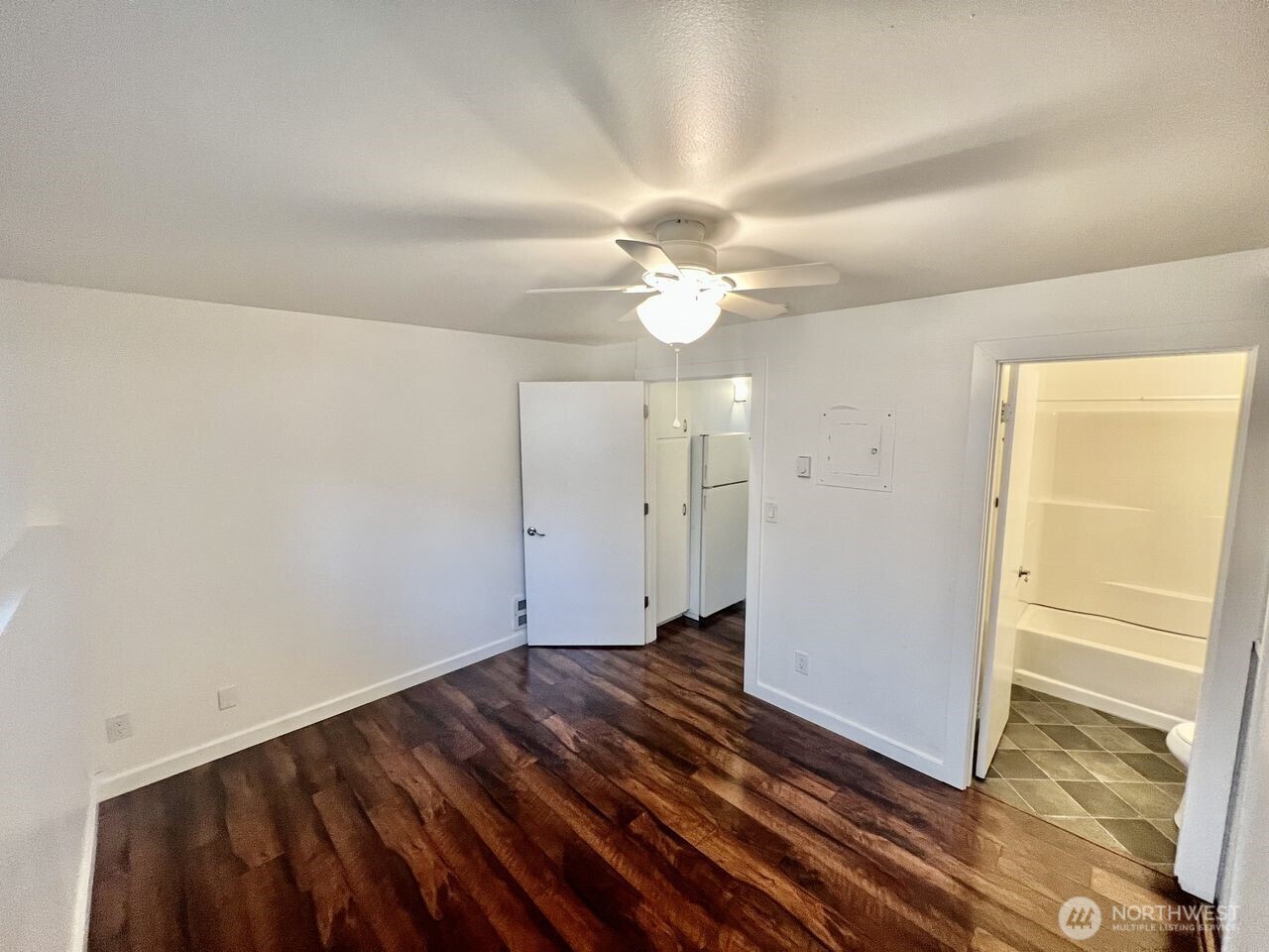 4200 Fremont Avenue North Seattle, WA 98103 - Photo 12 of 17 wooden floor in an empty room with a window