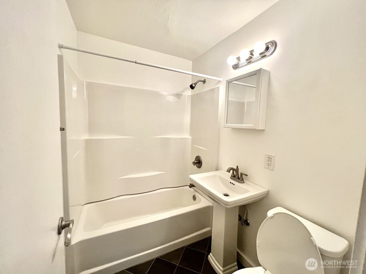 4200 Fremont Avenue North Seattle, WA 98103 - Photo 14 of 17 a bathroom with a sink mirror and toilet