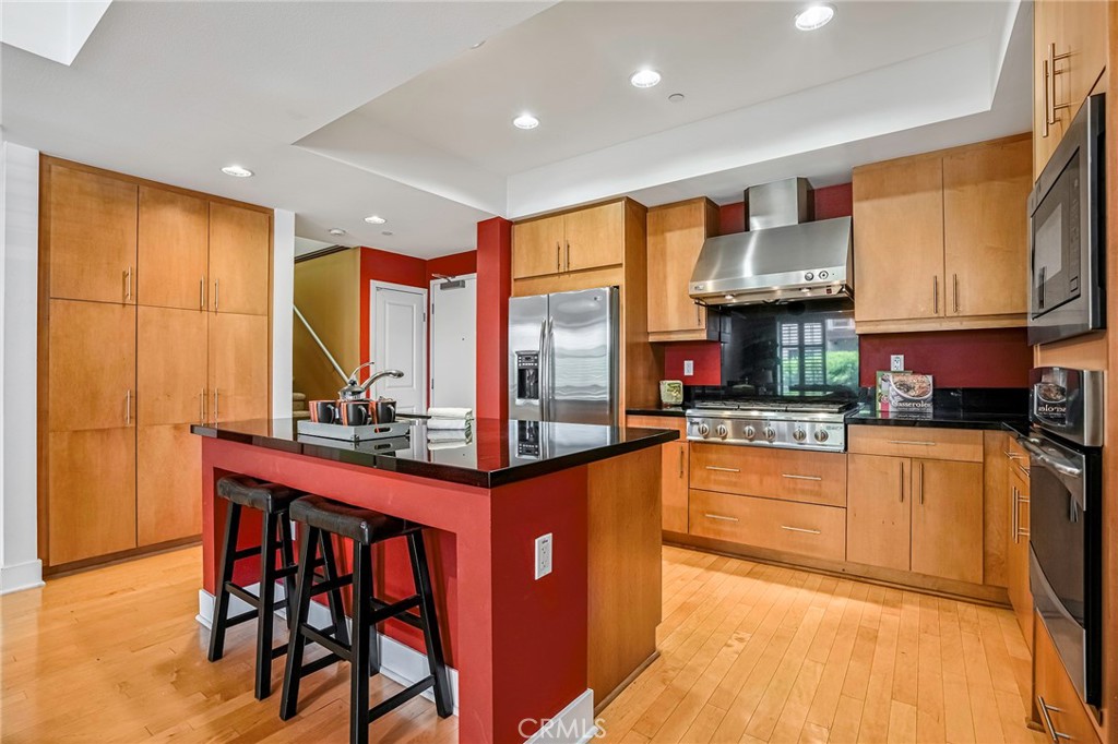 a kitchen with stainless steel appliances granite countertop a stove and a refrigerator