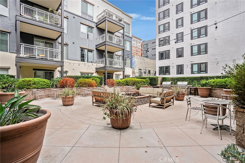 150 The Promenade North, Unit 202 Long Beach, CA 90802 - Photo 14 of 59 a view of a patio with couches table and chairs