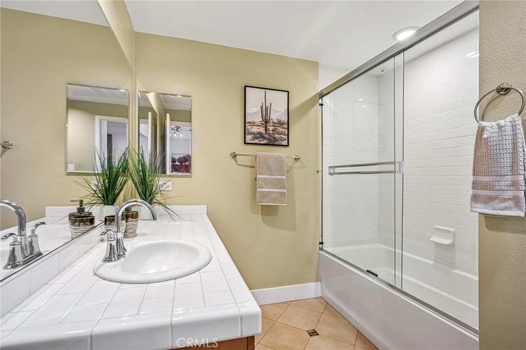 150 The Promenade North, Unit 202 Long Beach, CA 90802 - Photo 15 of 59 a bathroom with a sink and a mirror