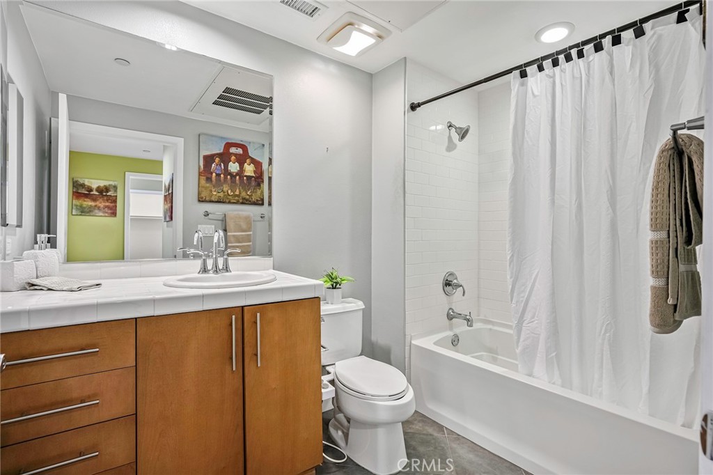 150 The Promenade North, Unit 202 Long Beach, CA 90802 - Photo 17 of 59 a bathroom with a granite countertop sink toilet and shower