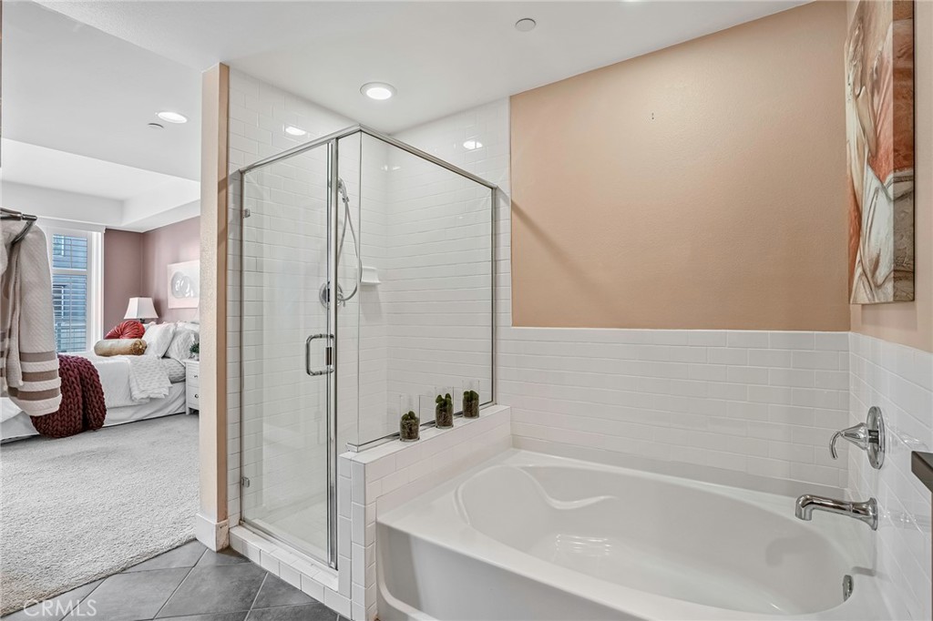 150 The Promenade North, Unit 202 Long Beach, CA 90802 - Photo 19 of 59 a bathroom with a tub and shower