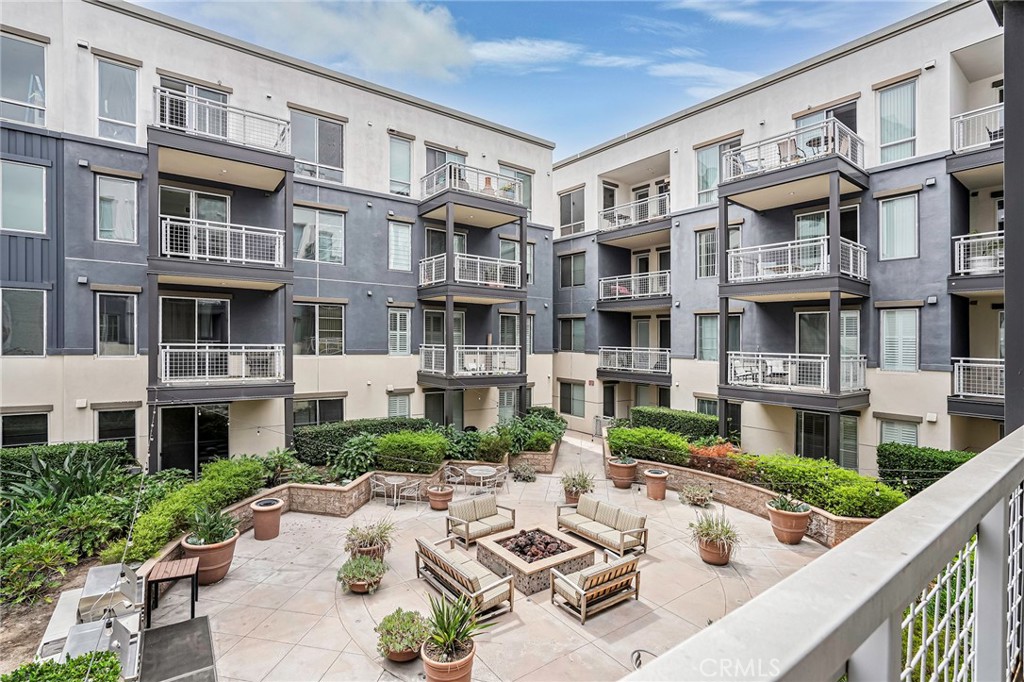 150 The Promenade North, Unit 202 Long Beach, CA 90802 - Photo 22 of 59 a view of a building with a garden and seating space