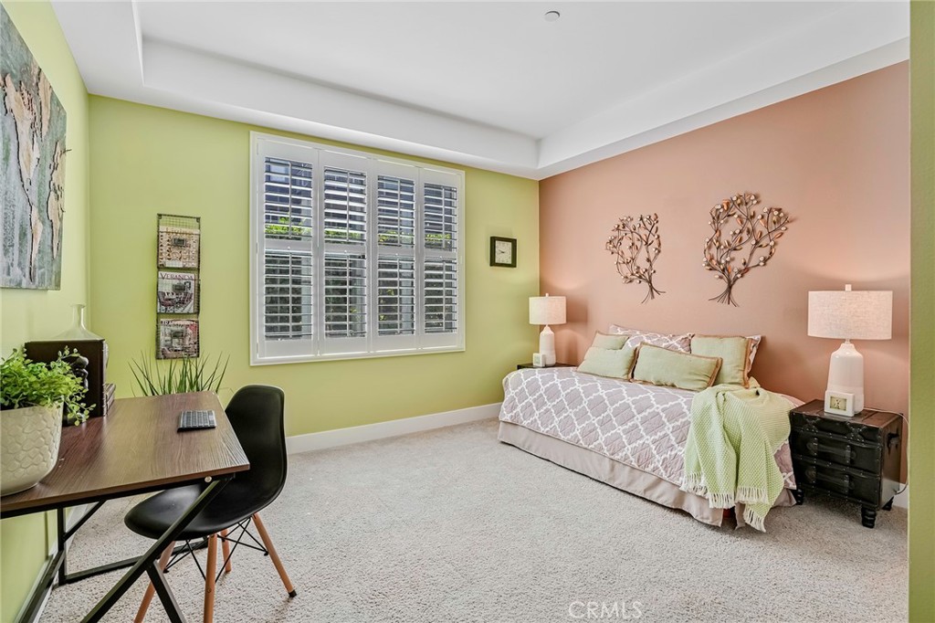 150 The Promenade North, Unit 202 Long Beach, CA 90802 - Photo 23 of 59 a bedroom with a bed and a window