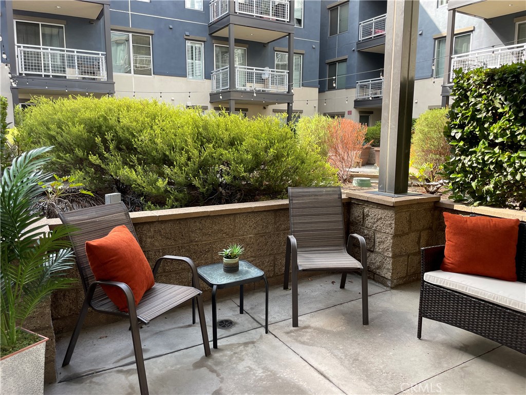 150 The Promenade North, Unit 202 Long Beach, CA 90802 - Photo 30 of 59 a view of a chairs and table in the patio in front of a house