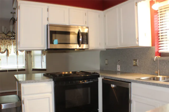 a kitchen with a sink cabinets and window