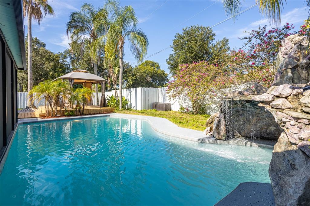 a swimming pool with outdoor seating and yard