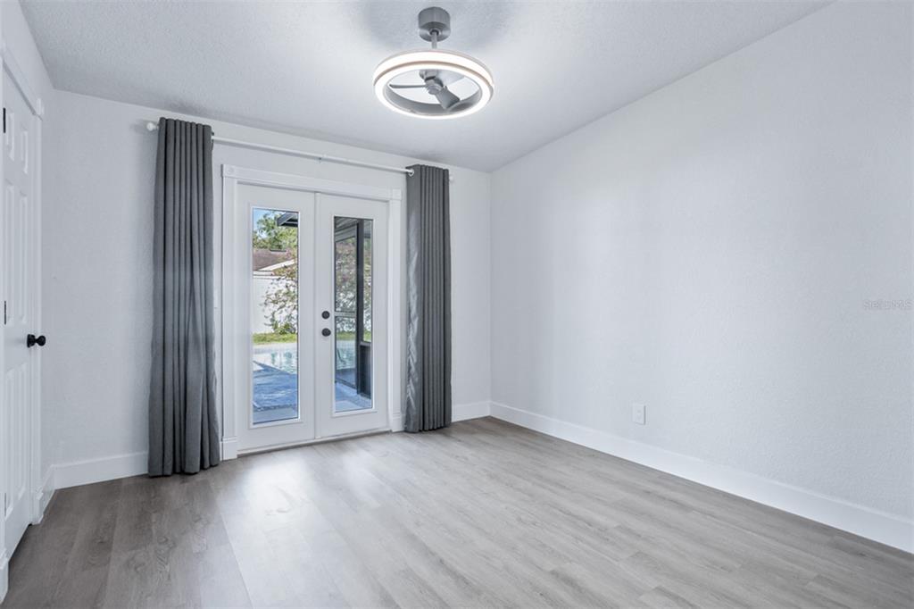 1231 Sidcup Road Maitland, FL 32751 - Photo 12 of 39 an empty room with wooden floor and windows