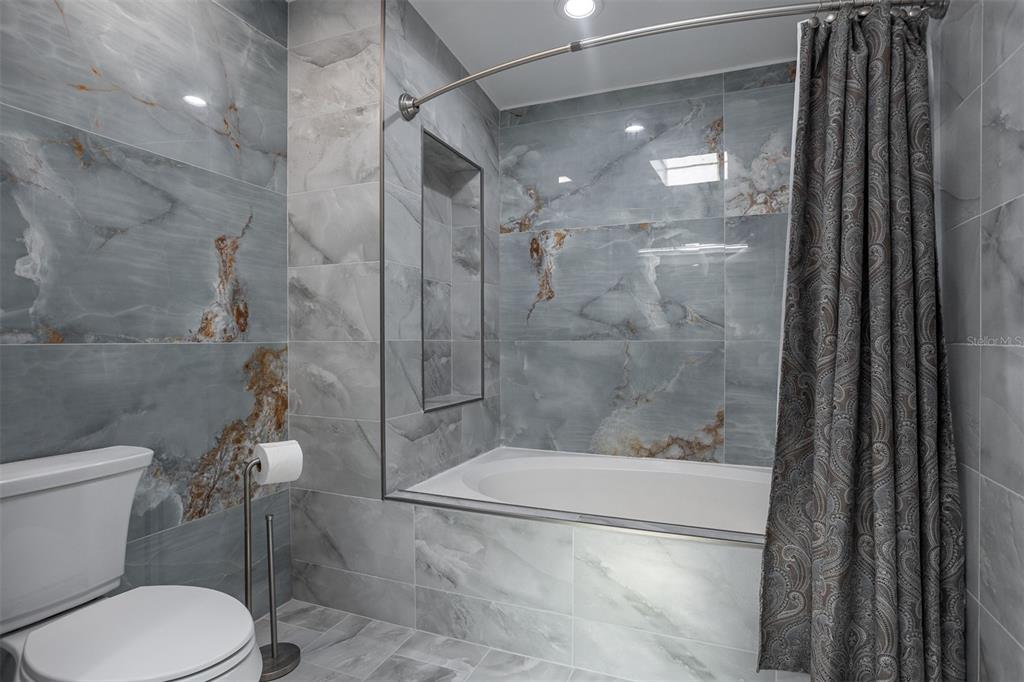 1231 Sidcup Road Maitland, FL 32751 - Photo 19 of 39 a bathroom with a shower and toilet