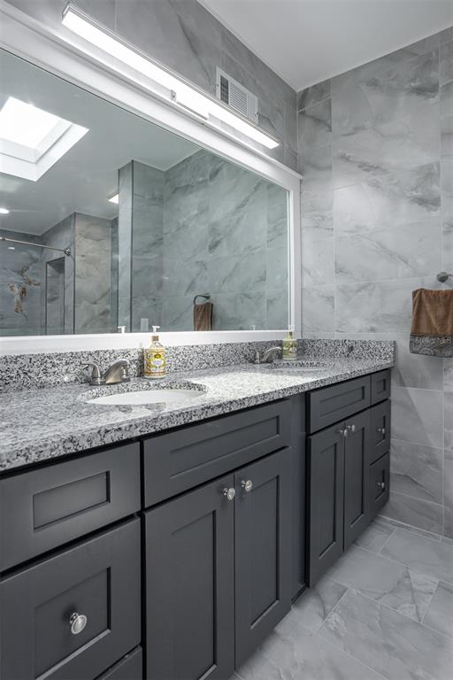1231 Sidcup Road Maitland, FL 32751 - Photo 21 of 39 a bathroom with a granite countertop sink and a mirror