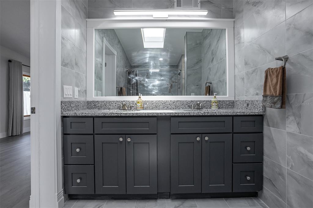 1231 Sidcup Road Maitland, FL 32751 - Photo 22 of 39 a bathroom with a granite countertop sink and a mirror