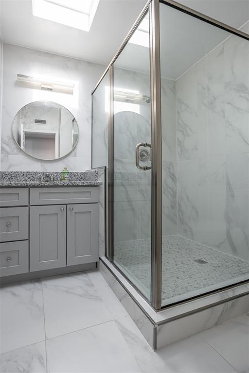1231 Sidcup Road Maitland, FL 32751 - Photo 24 of 39 a bathroom with a granite countertop sink a mirror and shower