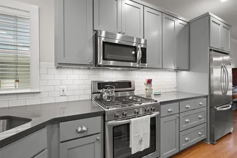 a kitchen with a sink stove and cabinets