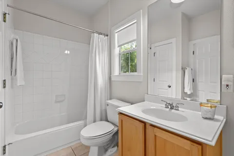 a bathroom with a sink toilet vanity and shower