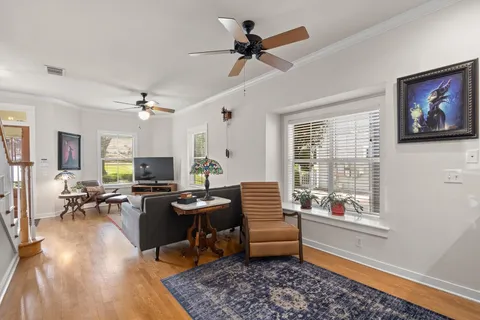 a living room with furniture a rug and a window
