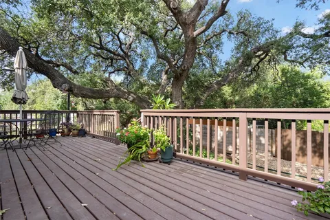 a porch with wooden floor yard and outdoor seating