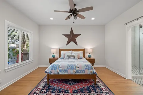 a bed sitting in a bedroom next to a window