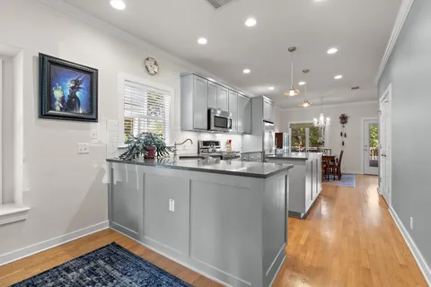 a kitchen with stainless steel appliances granite countertop a sink a stove and a refrigerator