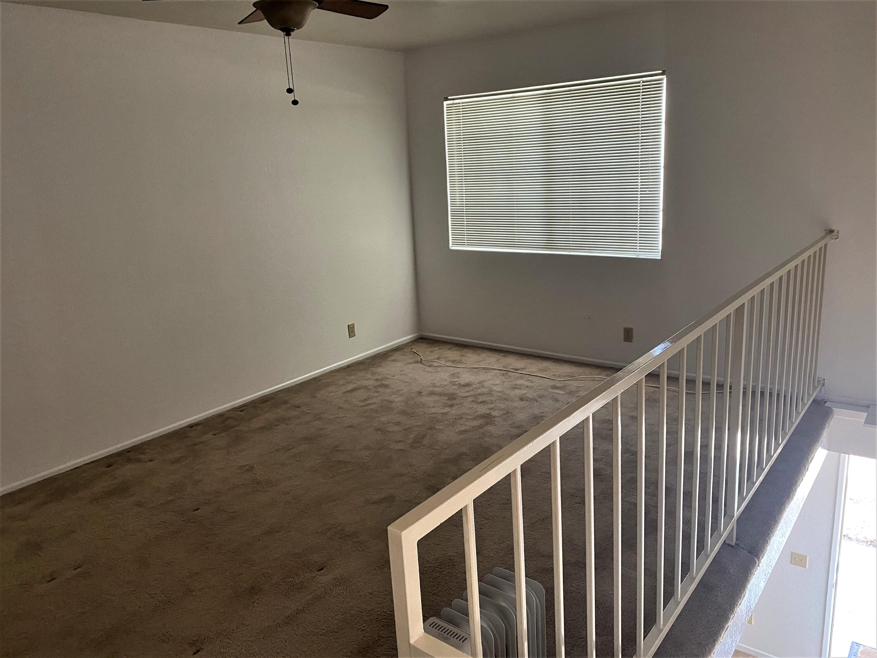 517 West Ward Avenue Ridgecrest, CA 93555 - Photo 11 of 18 a view of an empty room with wooden floor and a window