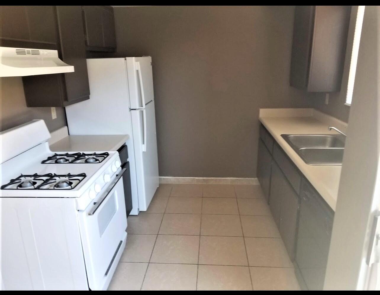 517 West Ward Avenue Ridgecrest, CA 93555 - Photo 14 of 18 a kitchen with a stove and a refrigerator