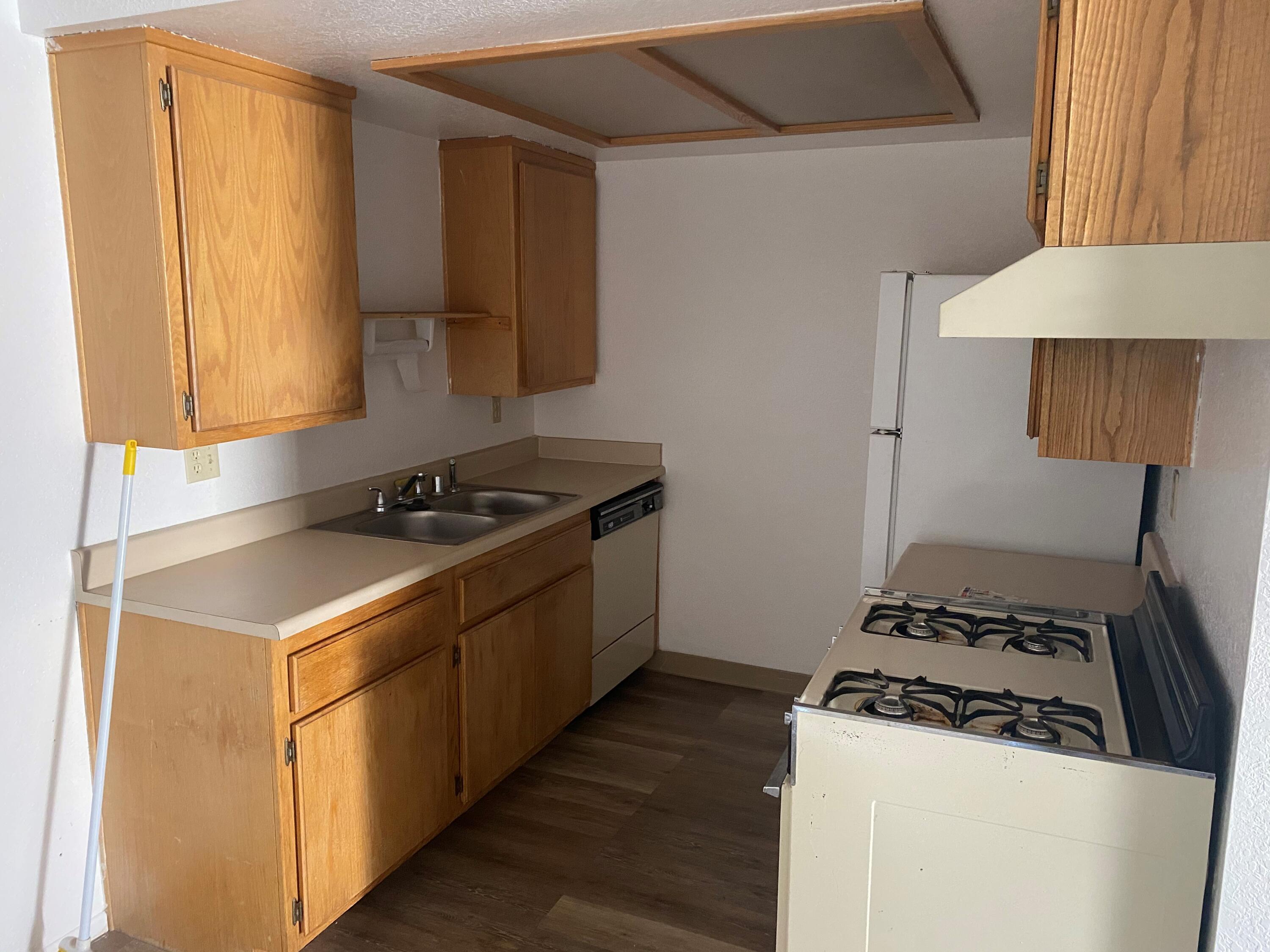 517 West Ward Avenue Ridgecrest, CA 93555 - Photo 8 of 18 a kitchen with a stove and a refrigerator