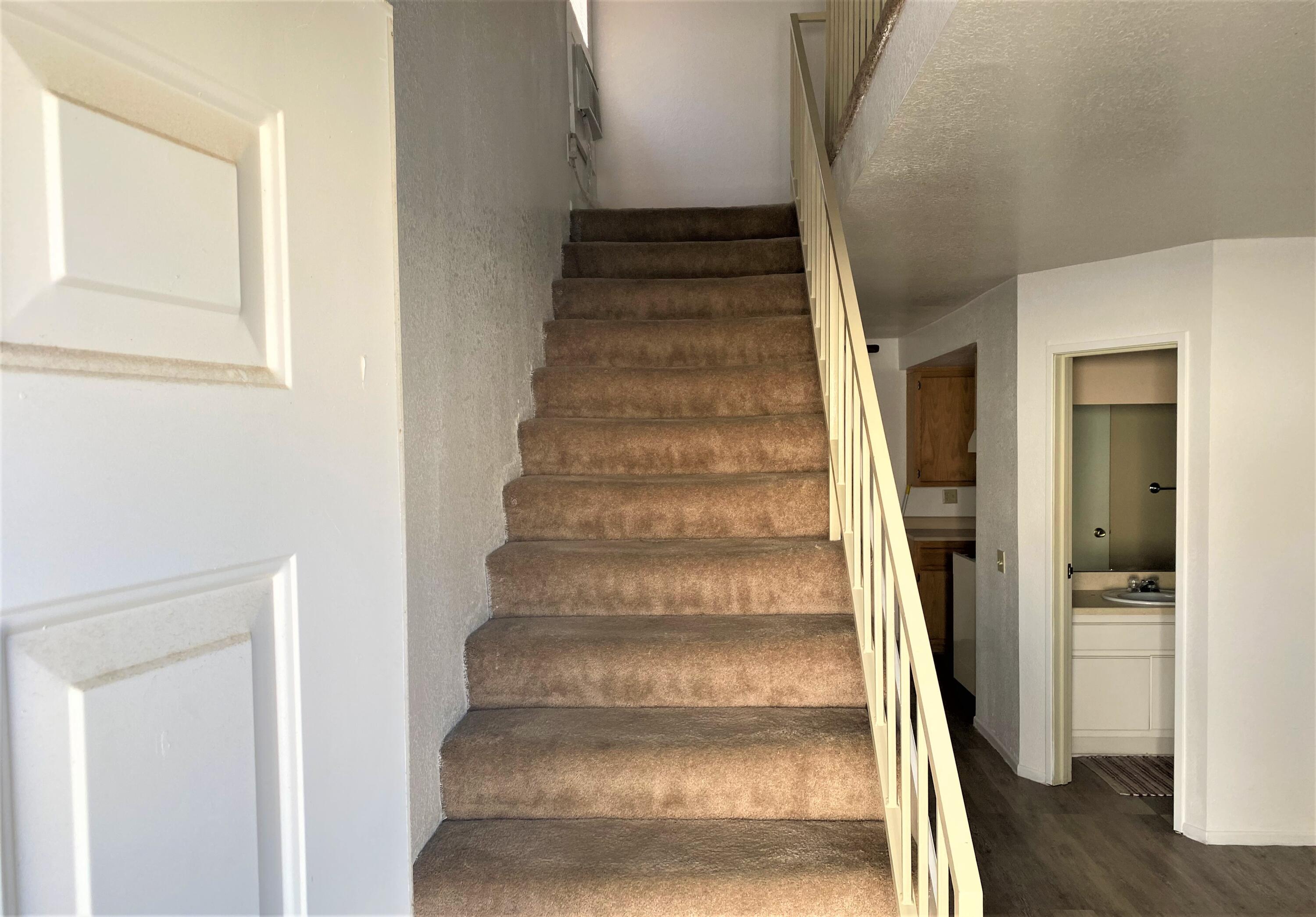 517 West Ward Avenue Ridgecrest, CA 93555 - Photo 10 of 18 a view of staircase with white walls and windows