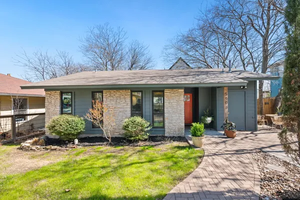 a front view of a brick house with a yard