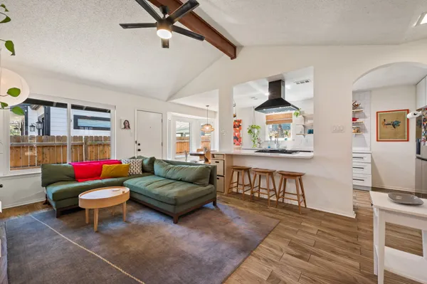 a living room with furniture and a wooden floor