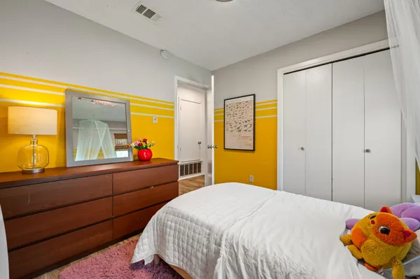 a bedroom with a bed and wooden floor