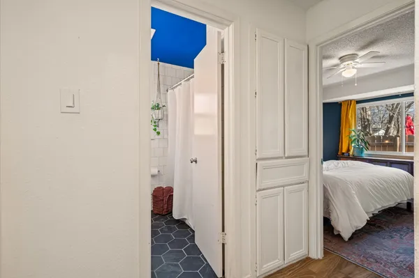a bedroom with a bed and a painting on the wall