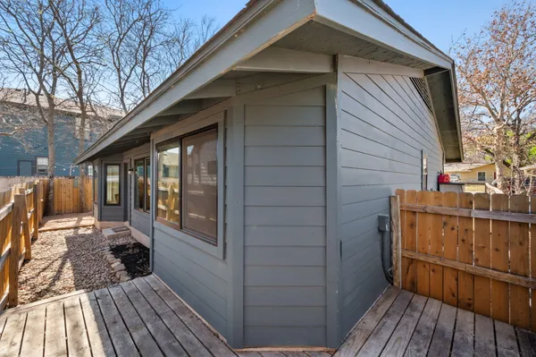 a view of a house with a wooden deck