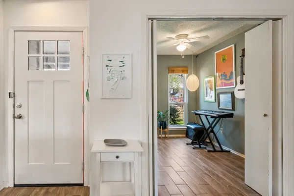 a view of a livingroom with wooden floor and workspace