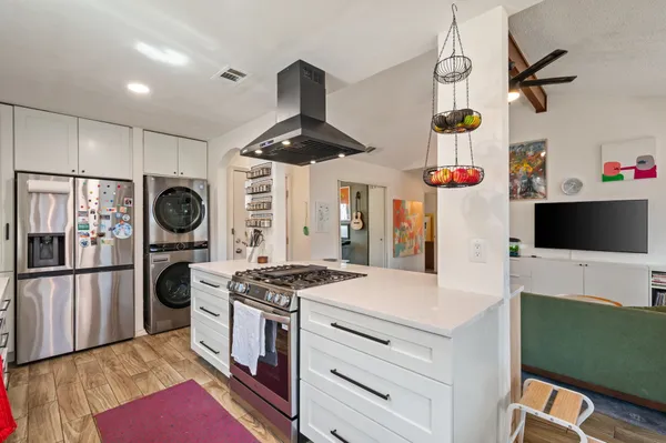 a kitchen with stainless steel appliances granite countertop a stove and a refrigerator