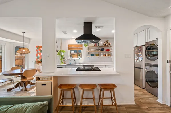 a kitchen with stainless steel appliances granite countertop a stove a sink and a refrigerator