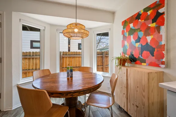 a view of a dining room with furniture and chandelier