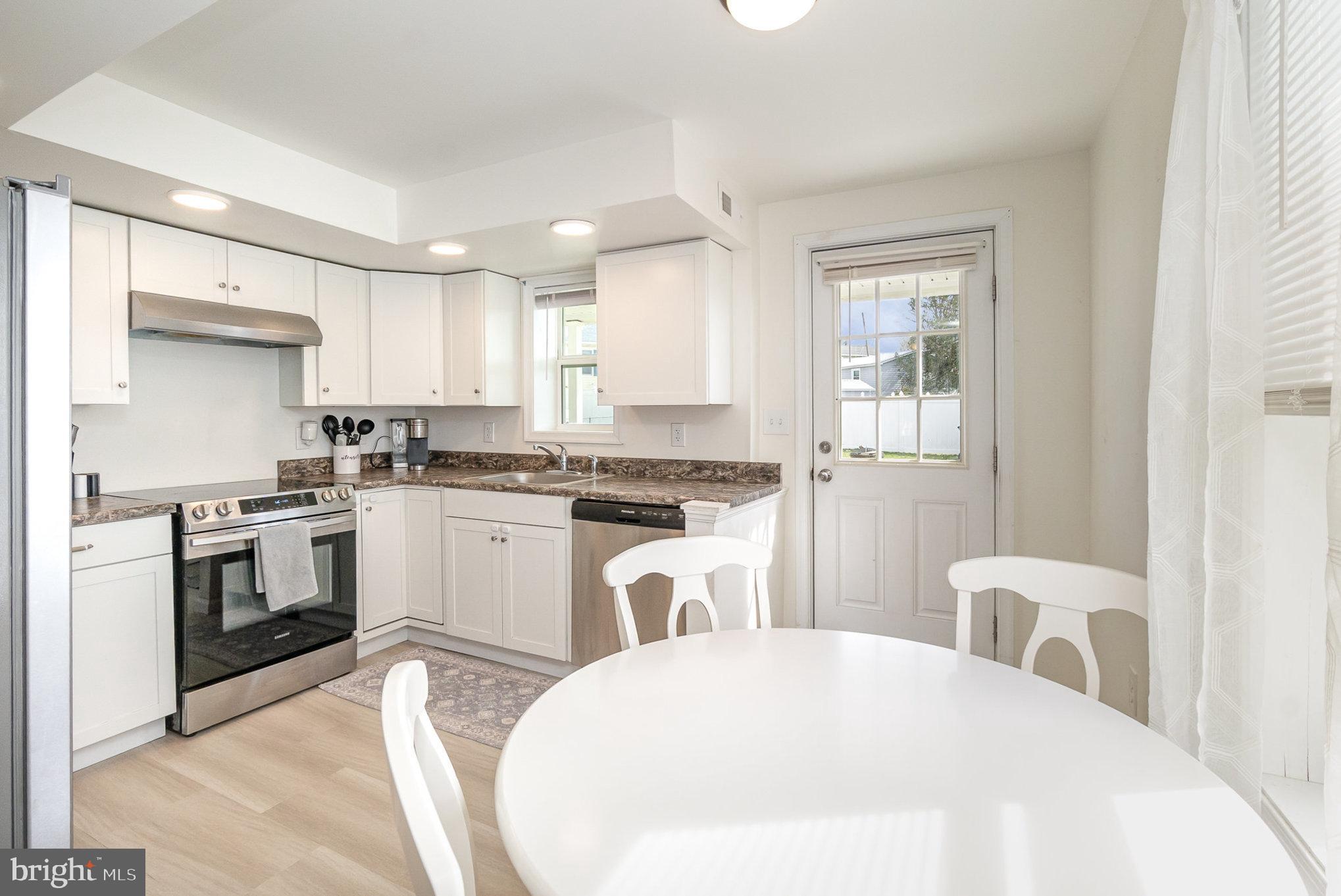 15 Mount Street Rising Sun, MD 21911 - Photo 3 of 30 a white kitchen with a stove a sink dishwasher and a refrigerator