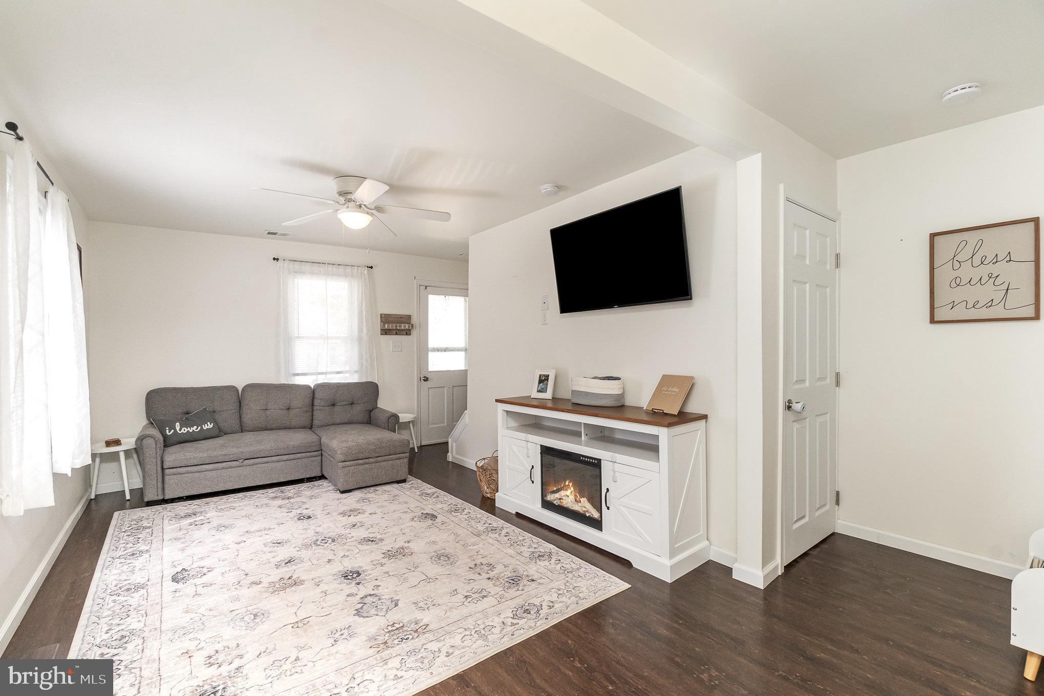 15 Mount Street Rising Sun, MD 21911 - Photo 10 of 30 a living room with furniture a flat screen tv and a fireplace