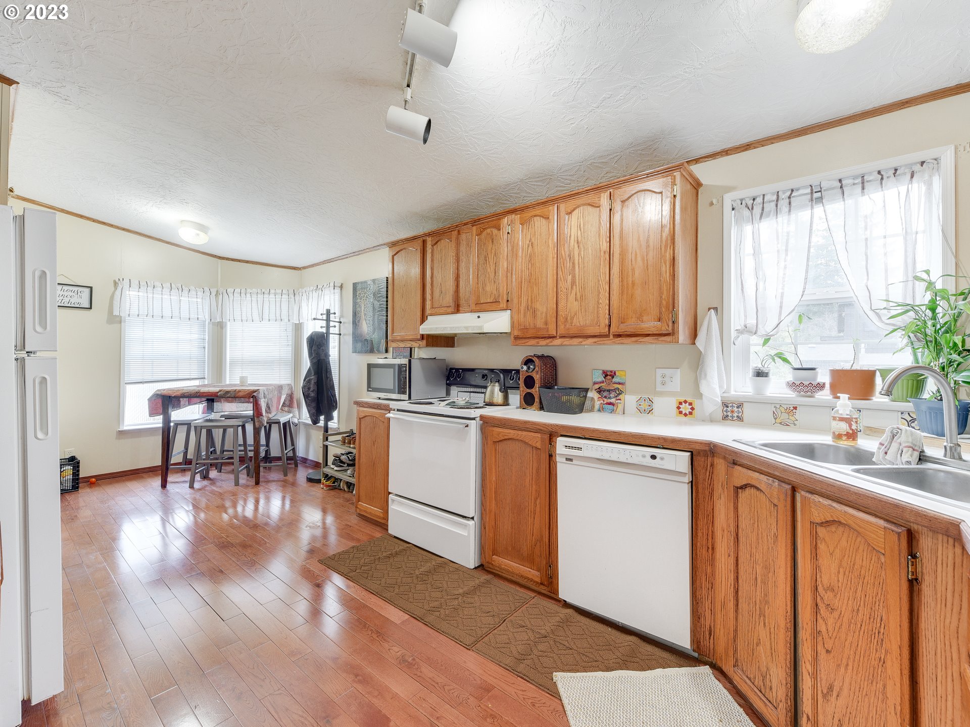 453 Southwest Hawthorn Road Estacada, OR 97023 - Photo 7 of 20 a kitchen with a table chairs sink and cabinets