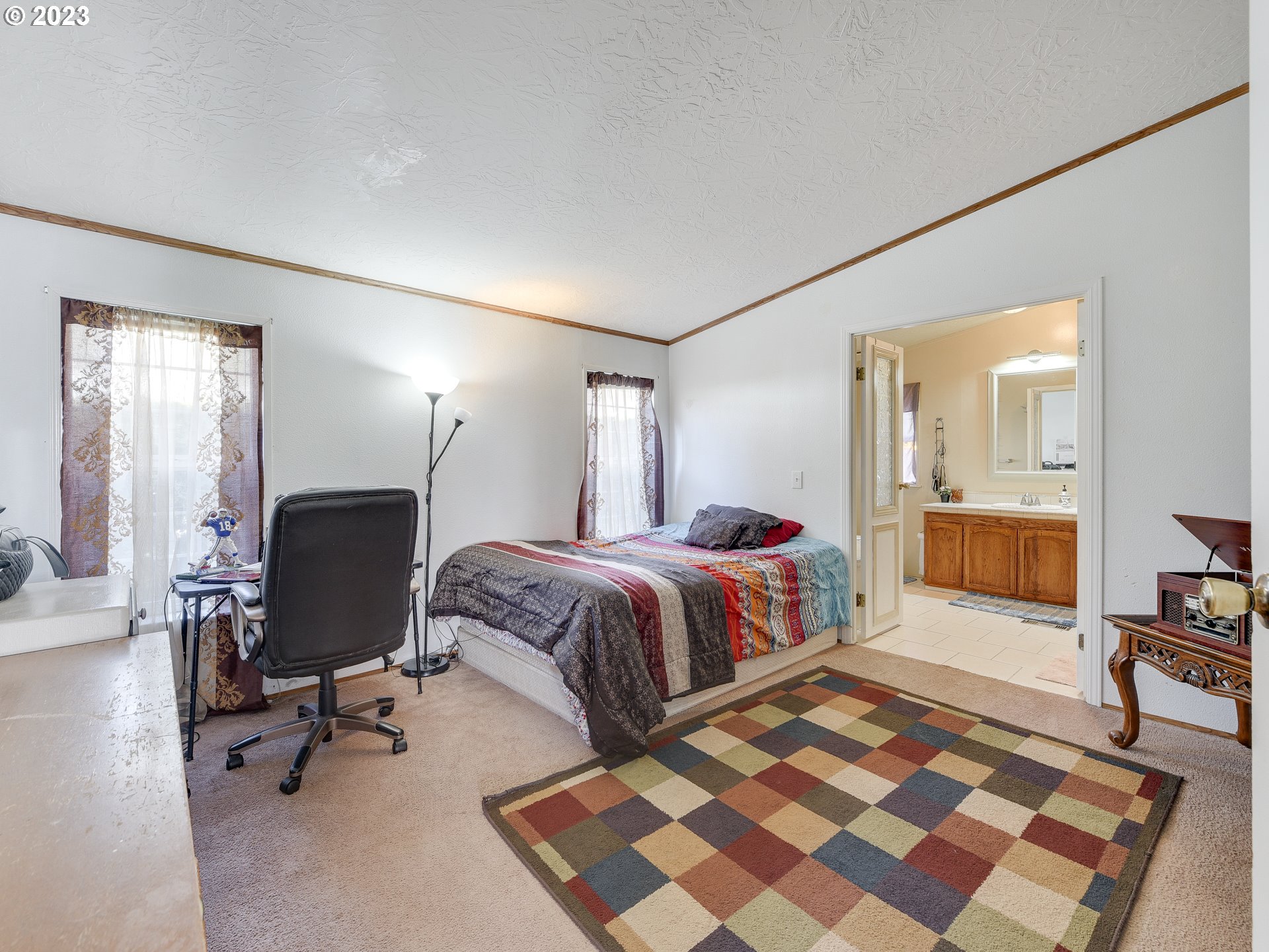 453 Southwest Hawthorn Road Estacada, OR 97023 - Photo 10 of 20 a spacious bedroom with a bed and wooden floor