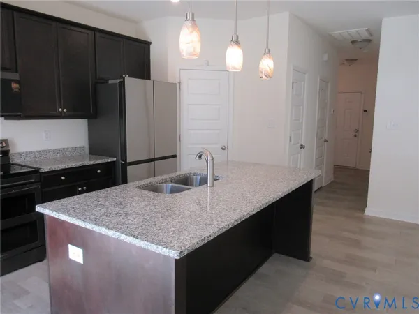 a kitchen with a sink a counter space and cabinets