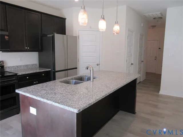 a kitchen with a sink a counter space and cabinets