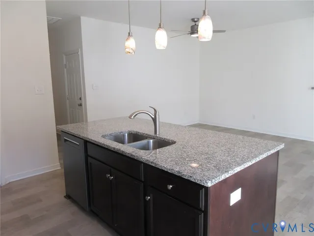 a kitchen with a sink a counter space and a window