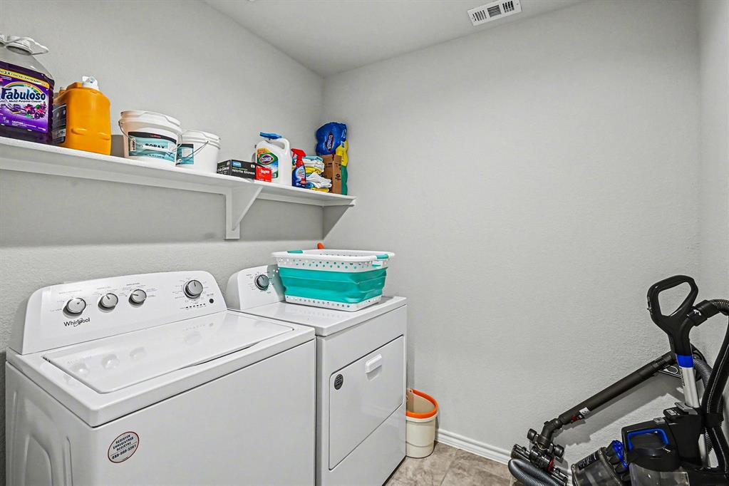 513 Bronze Circle West Springtown, TX 76082 - Photo 13 of 25 Dedicated laundry area featuring a washer and dryer, elevated wall shelving, and neutral wall finishes