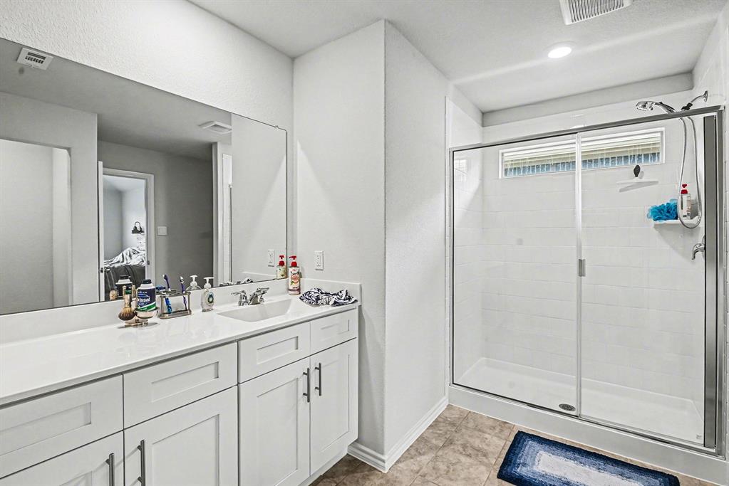 513 Bronze Circle West Springtown, TX 76082 - Photo 16 of 25 Bathroom featuring a double vanity with white cabinetry and a full-width mirror