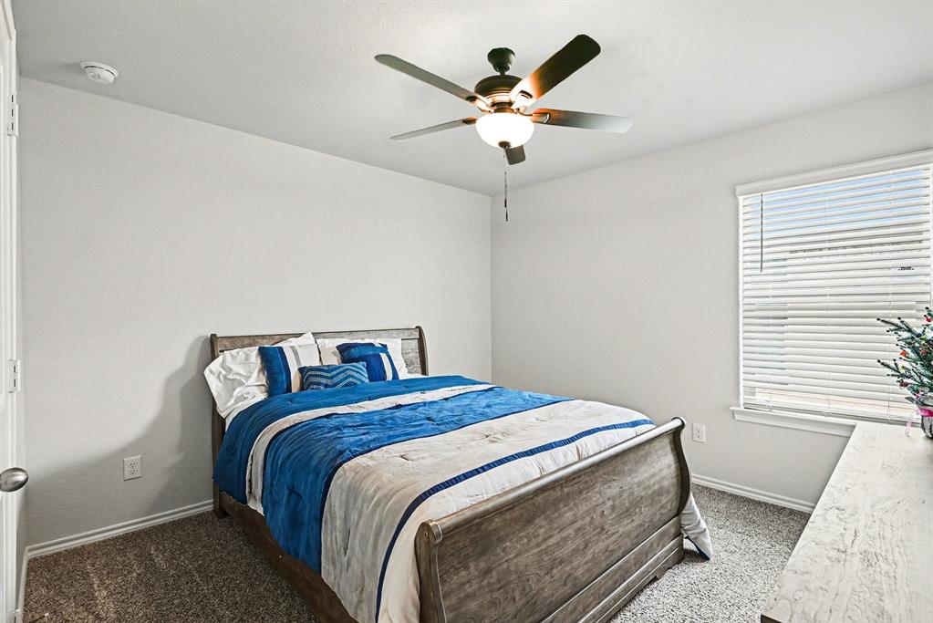 513 Bronze Circle West Springtown, TX 76082 - Photo 18 of 25 Carpeted bedroom featuring a ceiling fan with integrated lighting, a window with horizontal blinds, and neutral wall finishes