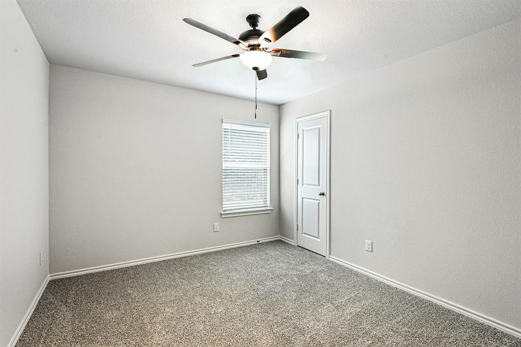 513 Bronze Circle West Springtown, TX 76082 - Photo 20 of 25 Room featuring neutral carpeting, light-toned walls, and a ceiling fan with integrated lighting