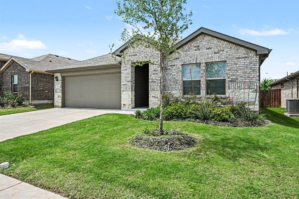 513 Bronze Circle West Springtown, TX 76082 - Photo 3 of 25 Single-story residence featuring a light brick and stone exterior with a gray garage door