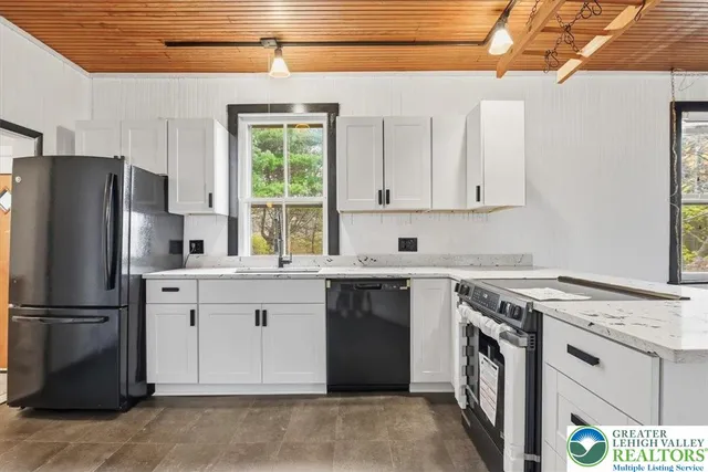 a kitchen with a stove and white cabinets
